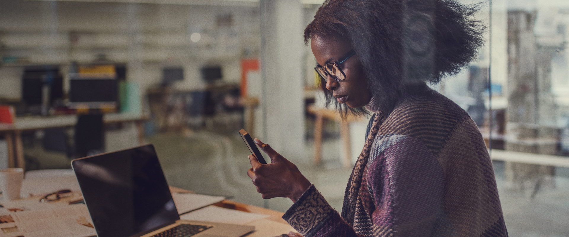 QuickBooks lady on mobile phone in office