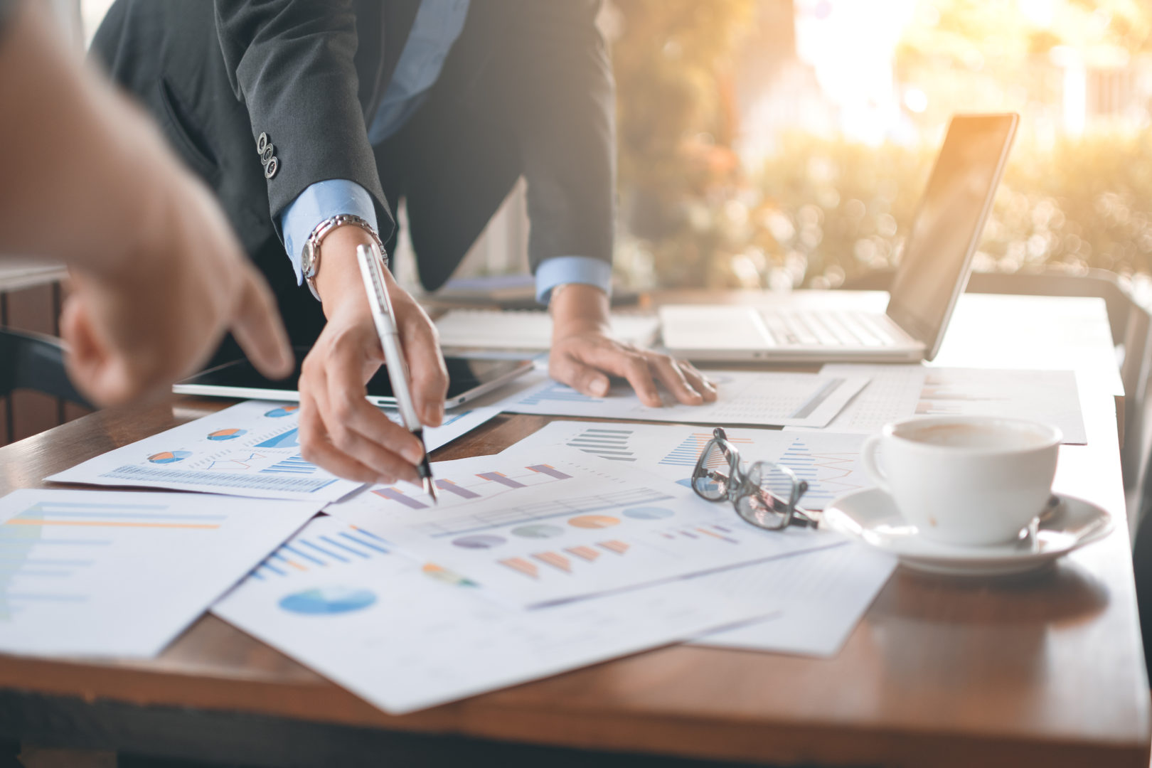 Accounting & Financial service, pen pointing at reports on desk image