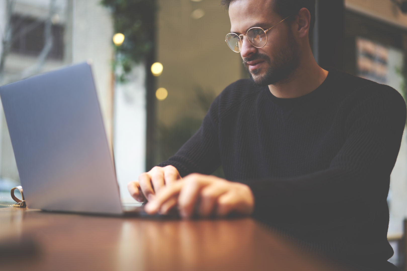 The hybrid cloud, Small business guy with glasses at laptop photo